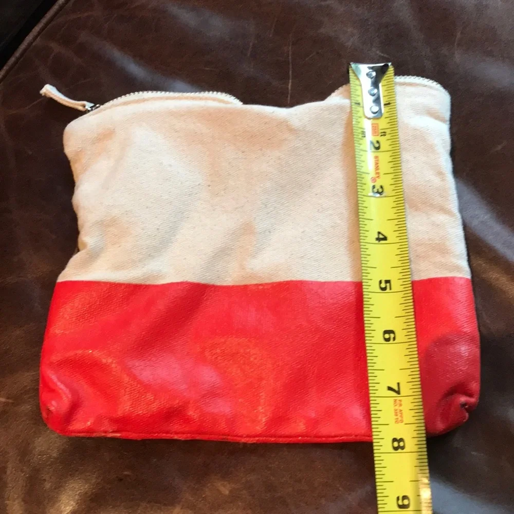 Cosmetic or pencil bag with vinyl orange bottom